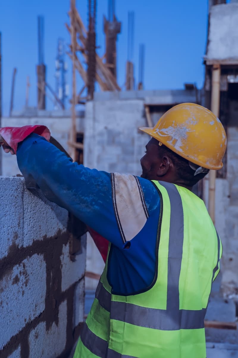 Construction worker laying block on a building site